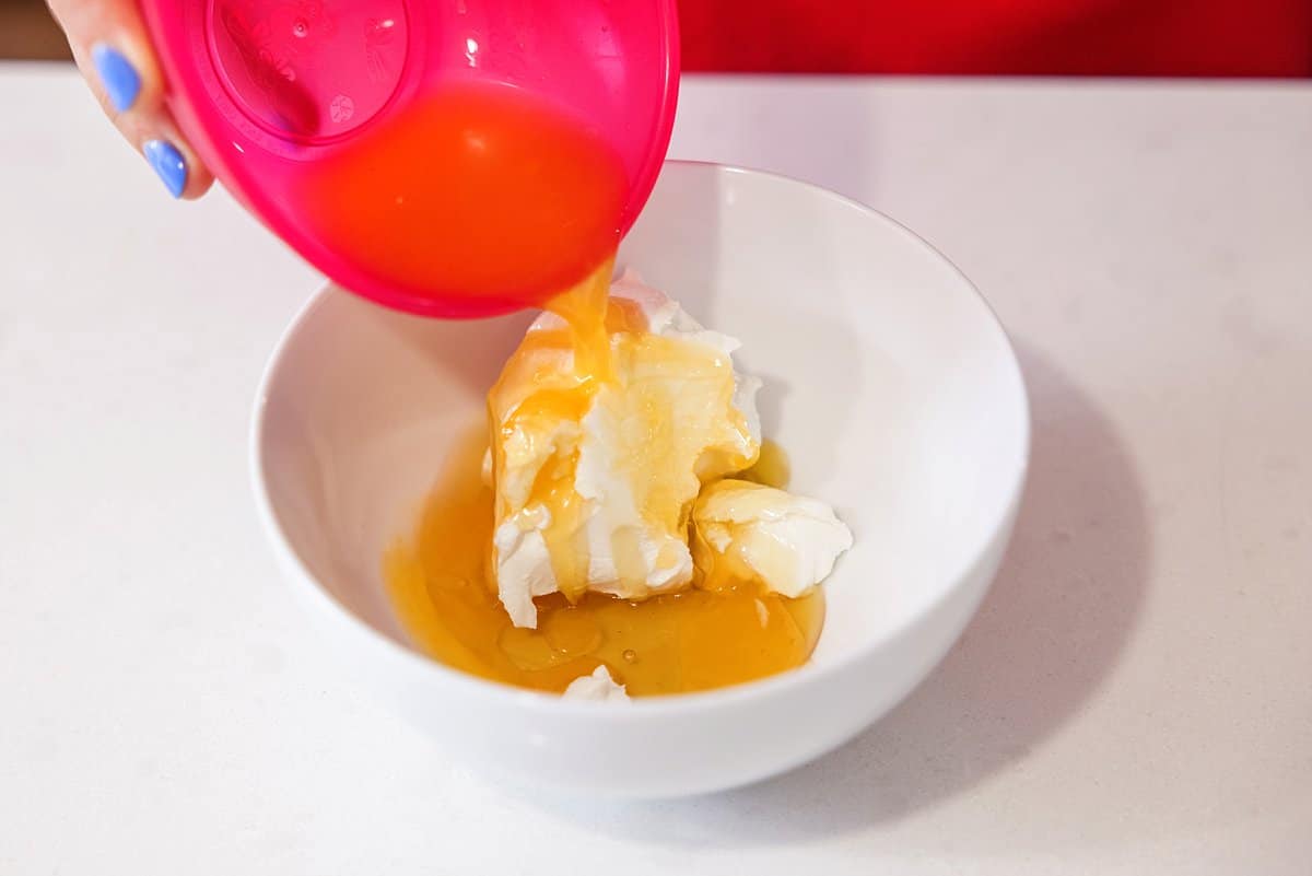 Adding tangerine juice to bowl