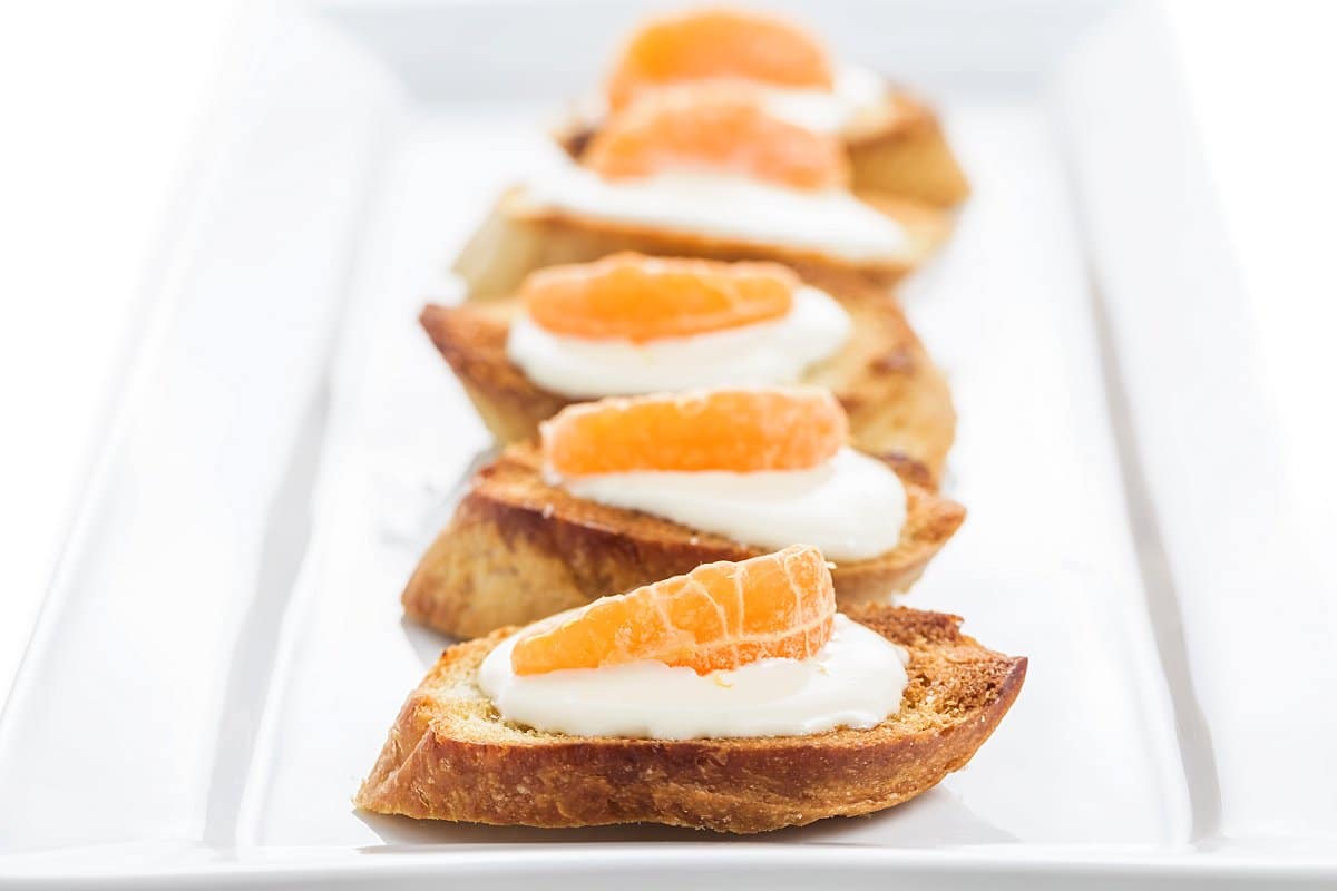 Plate of honey tangerine goat cheese crostini.