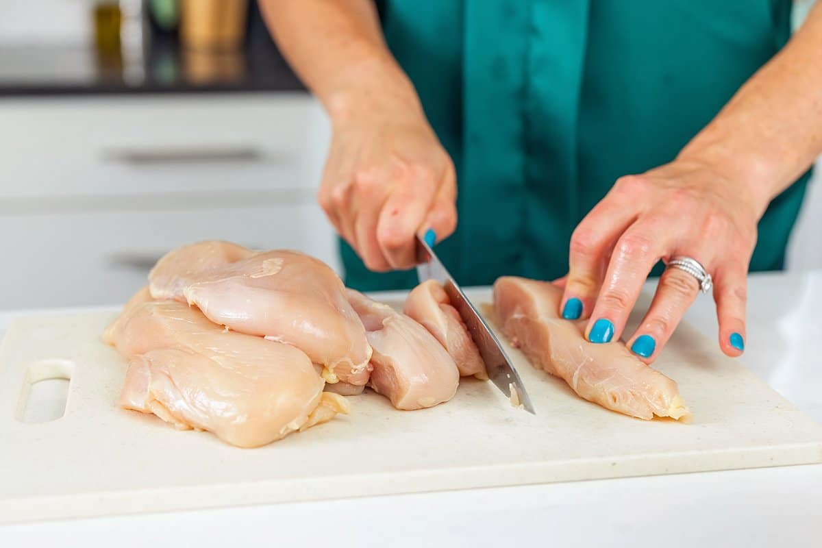 Liz cutting chicken for stir fry.