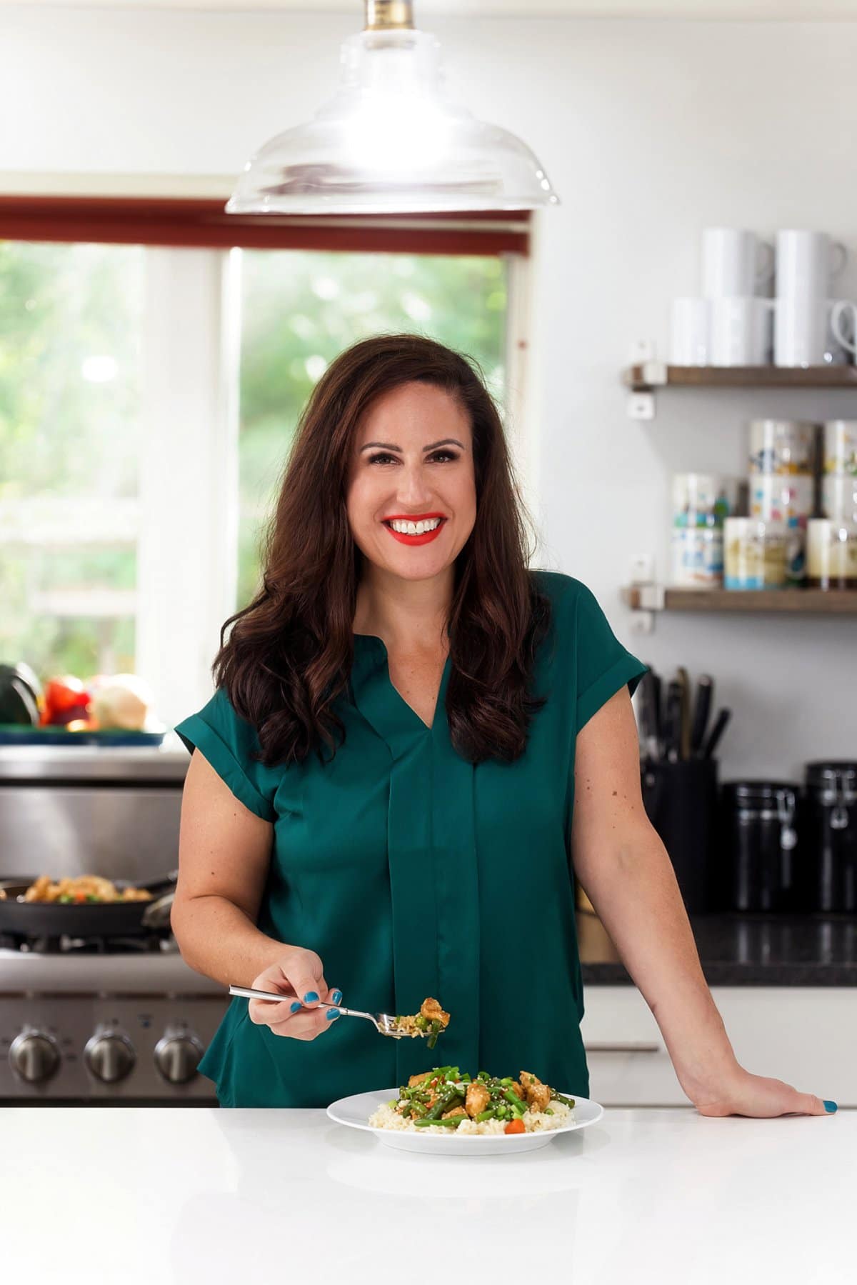 Liz enjoying sesame chicken and green bean stir fry.