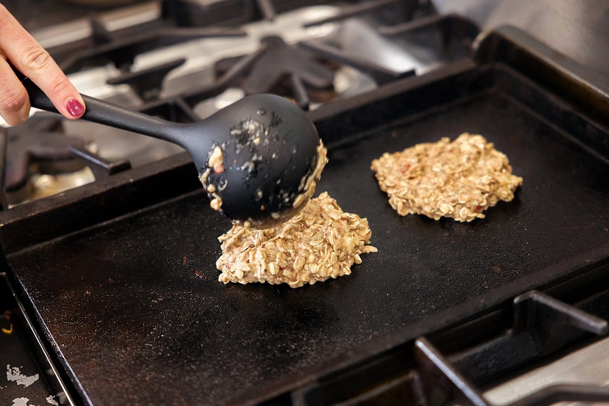 Protein pancakes cooking on a griddle.