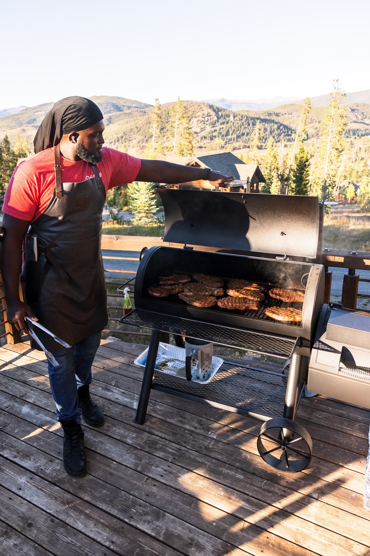 A person grilling steaks