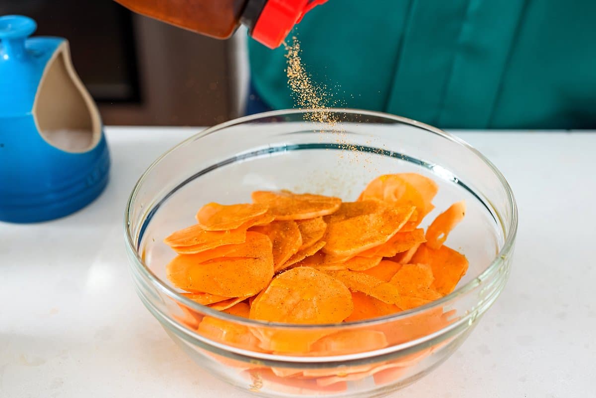A bowl of cut raw sweet potatoes