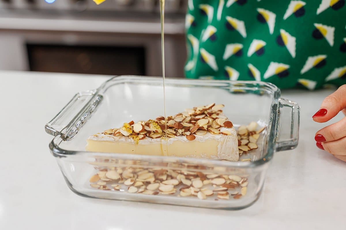 Brie with almonds on top with honey drizzle