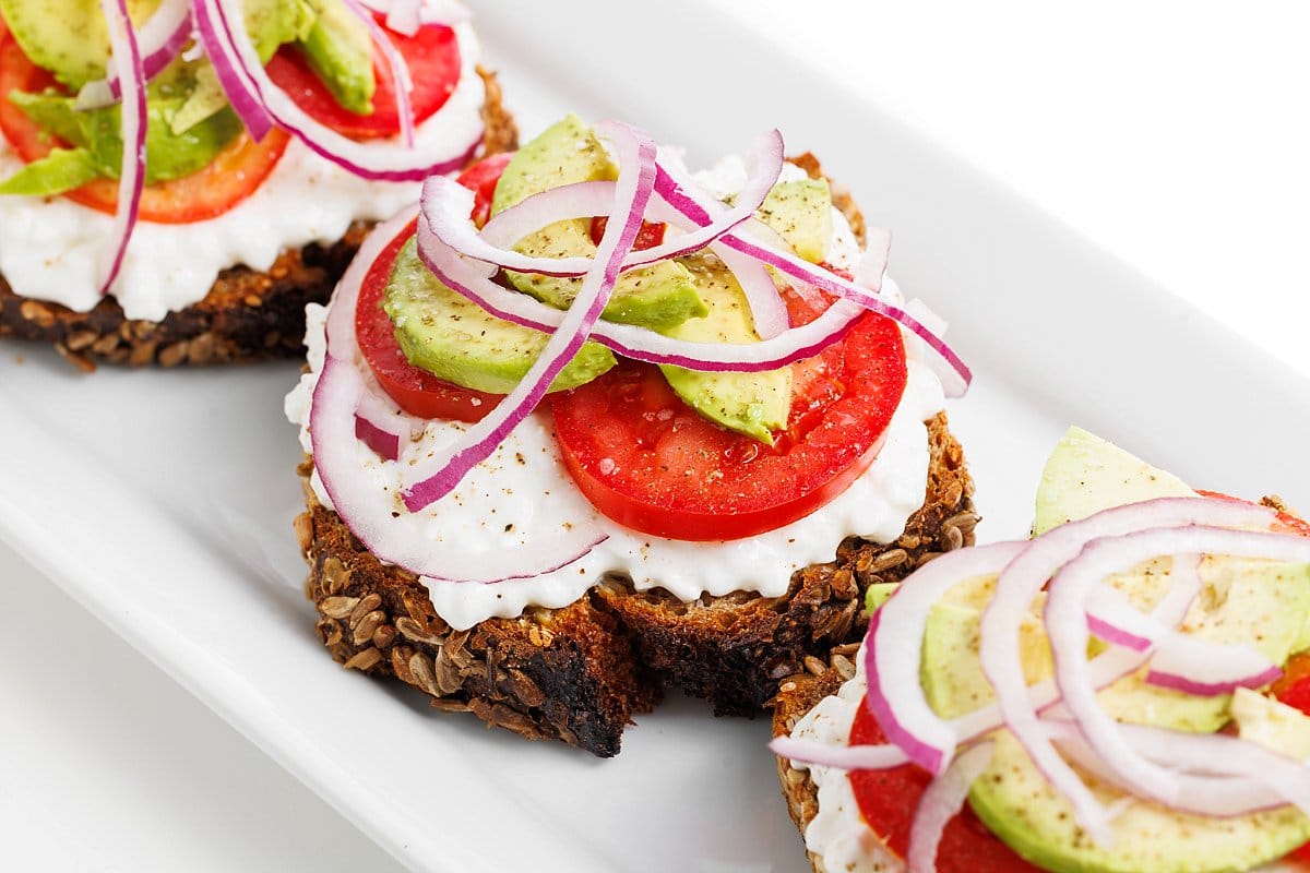 high protein breakfast- avocado toast with cottage cheese and tomatoes.