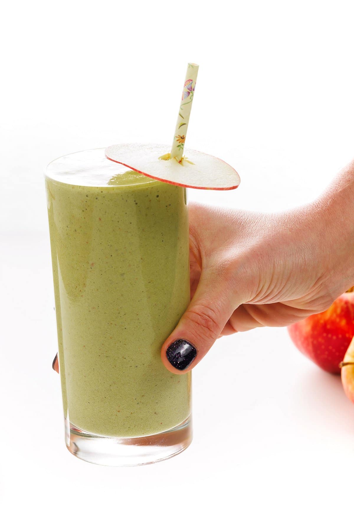 Holding carrot apple ginger green smoothie