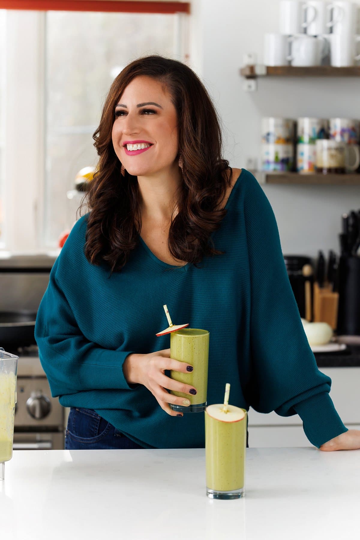 Liz drinking carrot apple ginger green smoothie