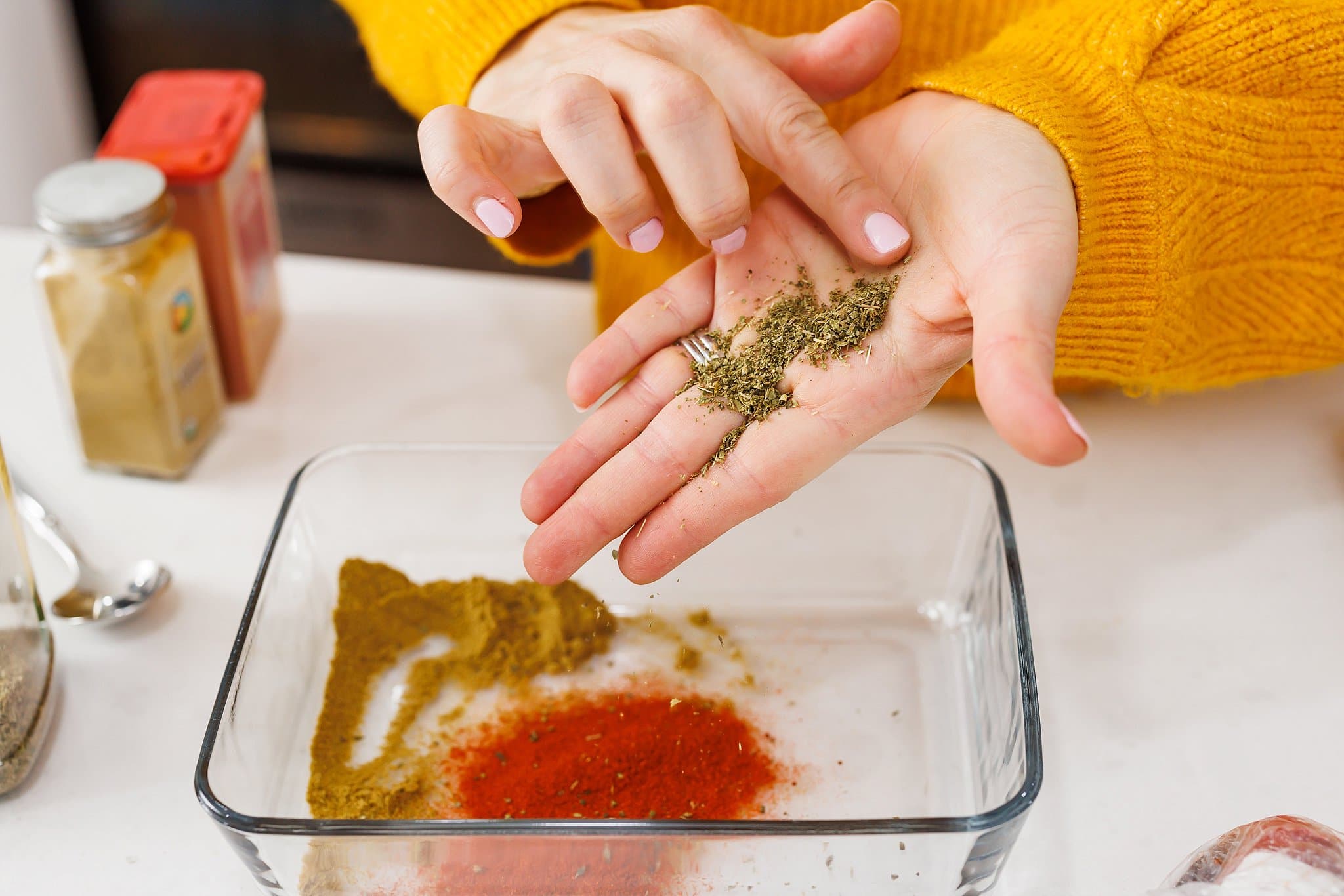Adding pepper to glass with with other spices.