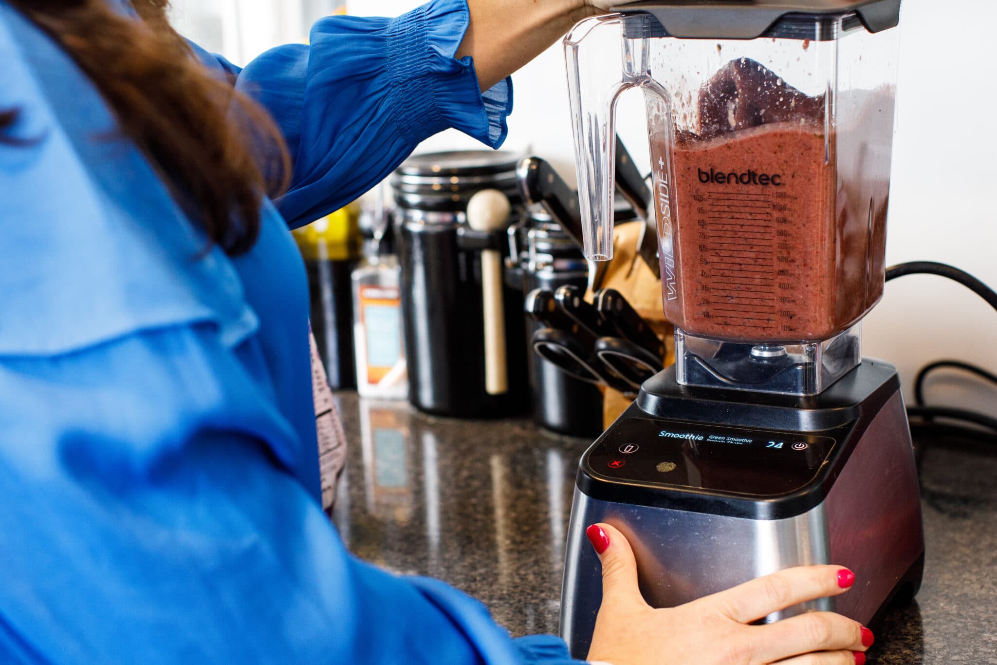 Blending ginger berry smoothie in high speed blender.
