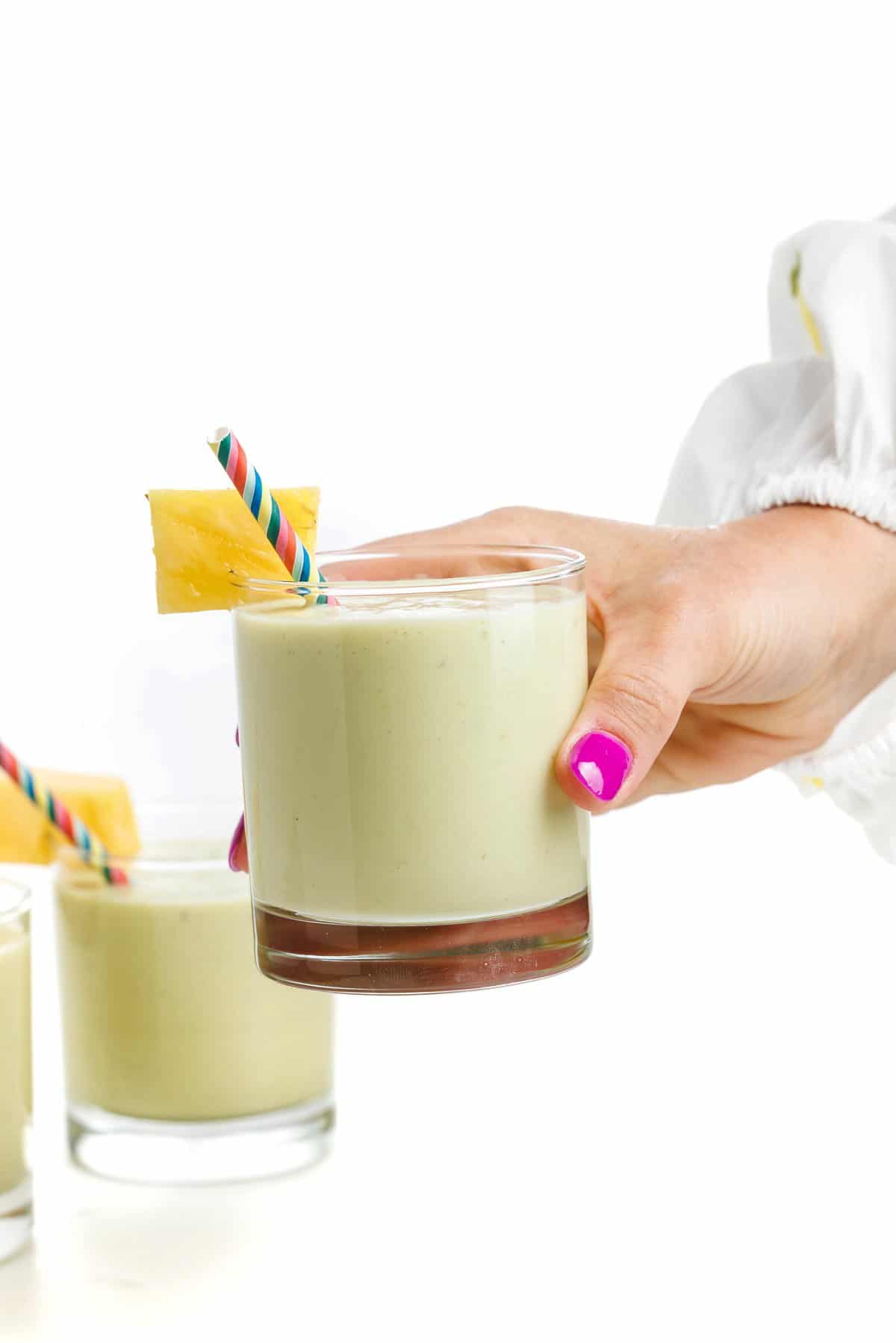 Holding pineapple banana avocado smoothie.