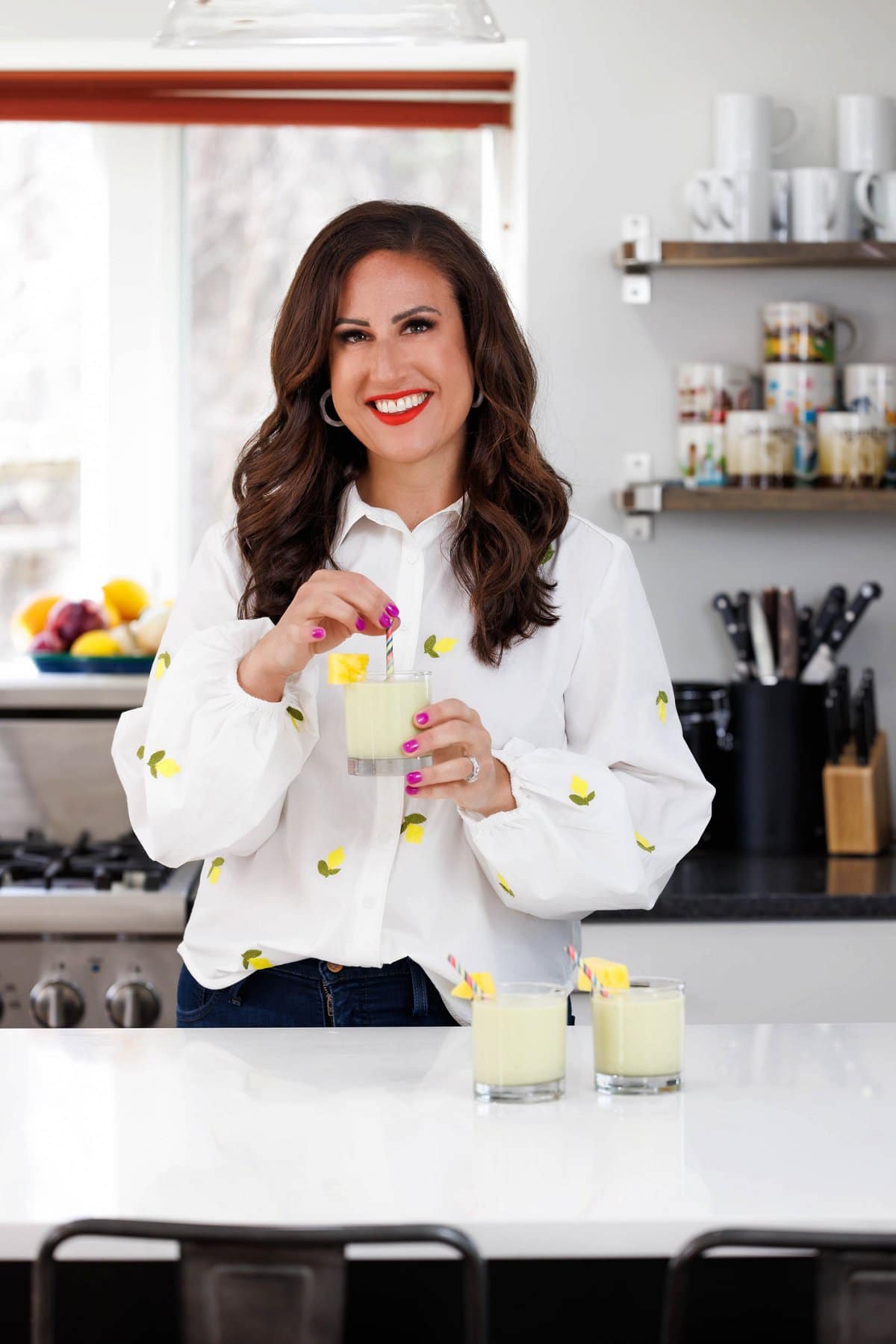 Liz drinking pineapple banana avocado smoothie.