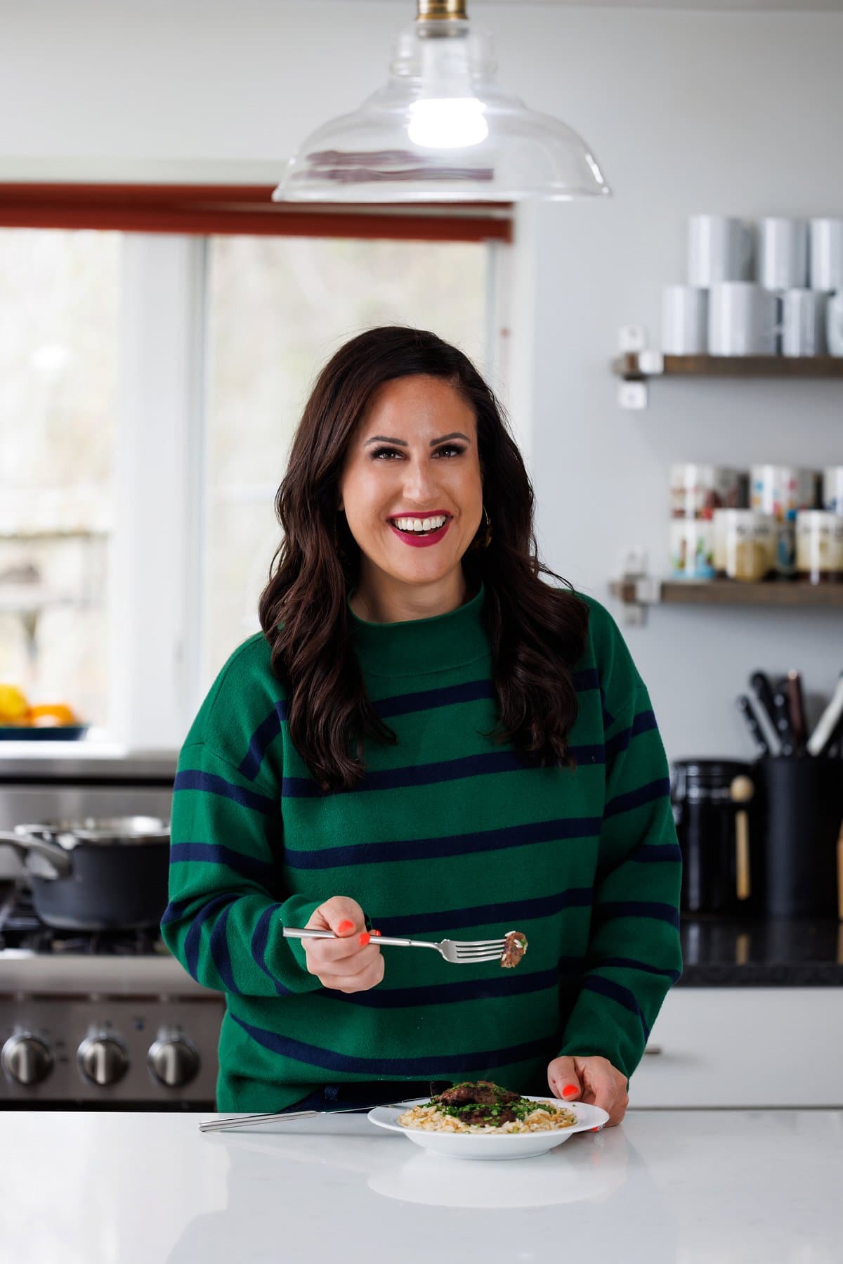Liz eating grilled Lebanese beef kafta patties.