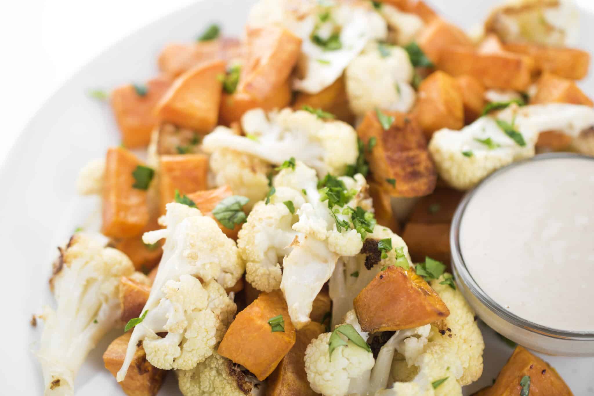 Roasted vegetables with tahini lemon sauce.