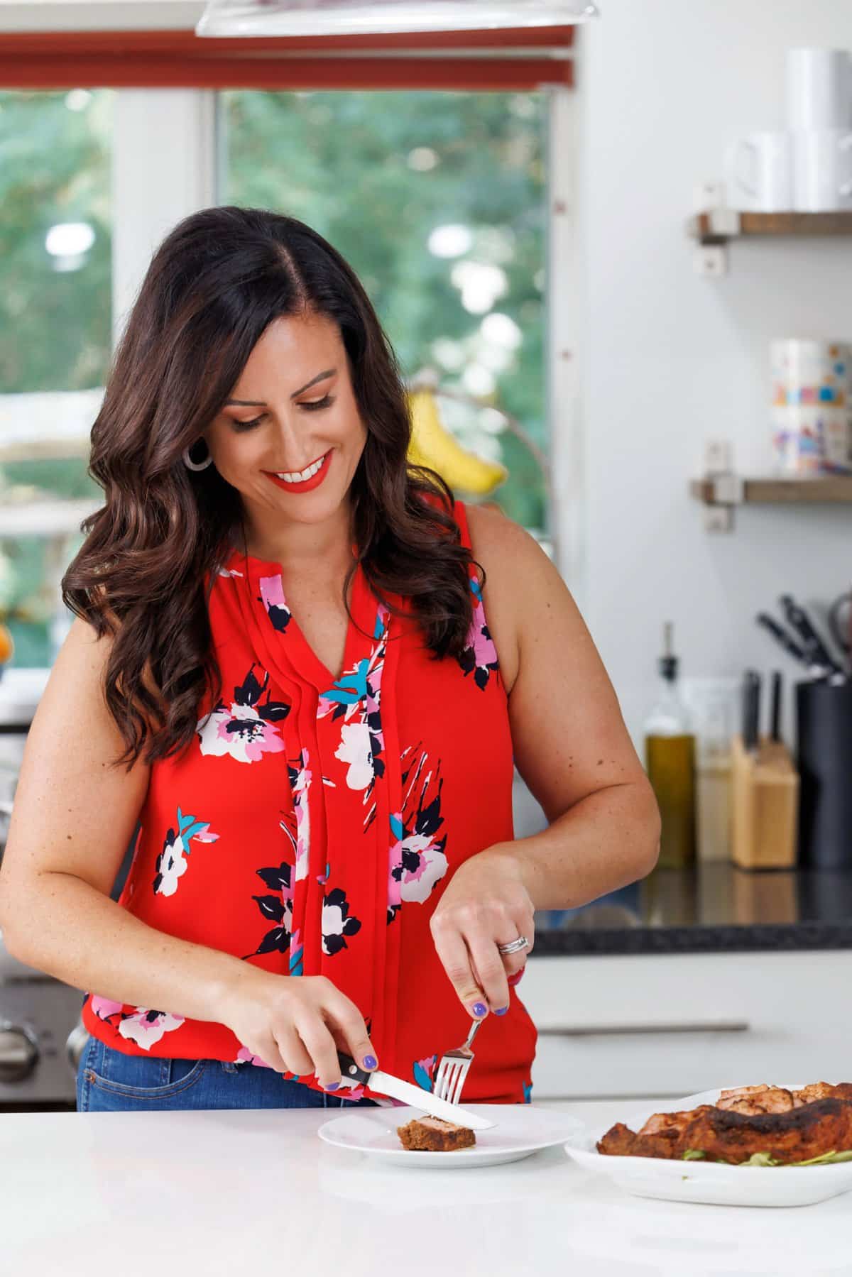 Liz cutting easy roasted spice-rubbed pork tenderloin.
