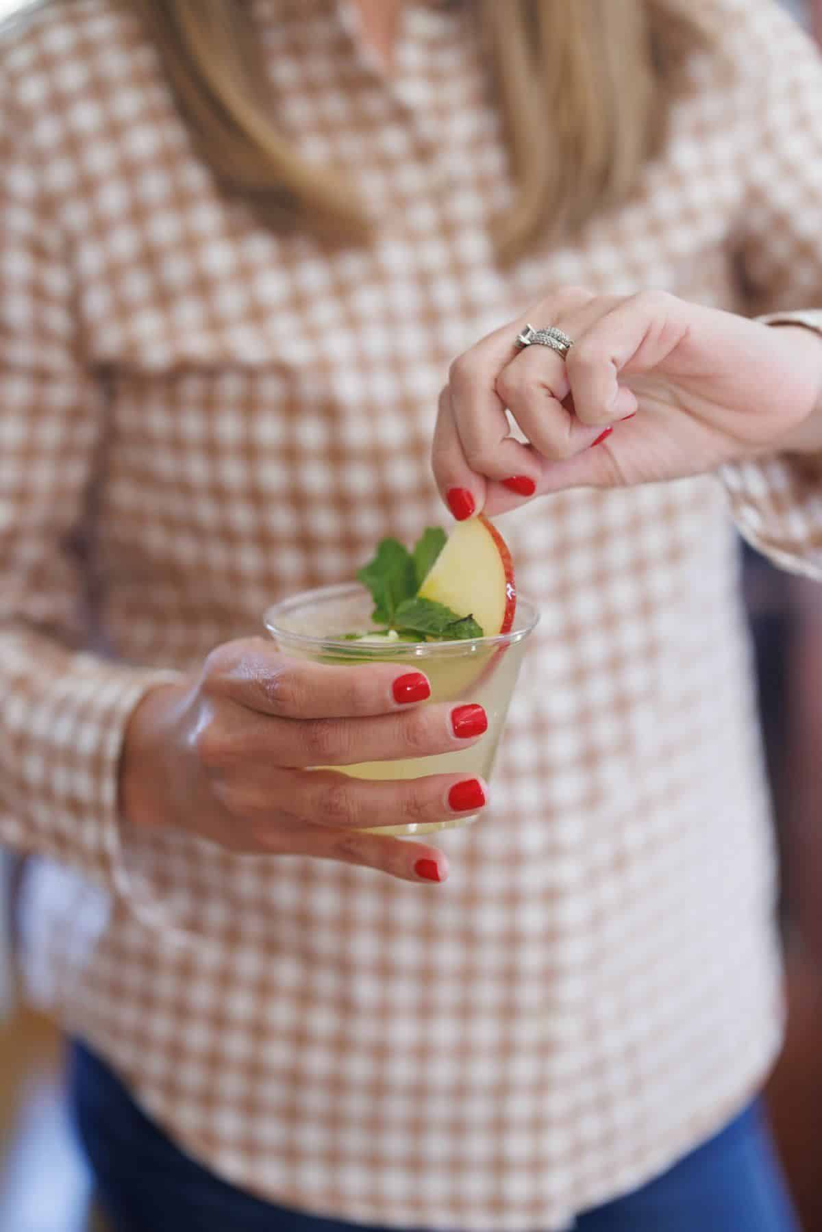 Holding spicy apple Moscow mule.