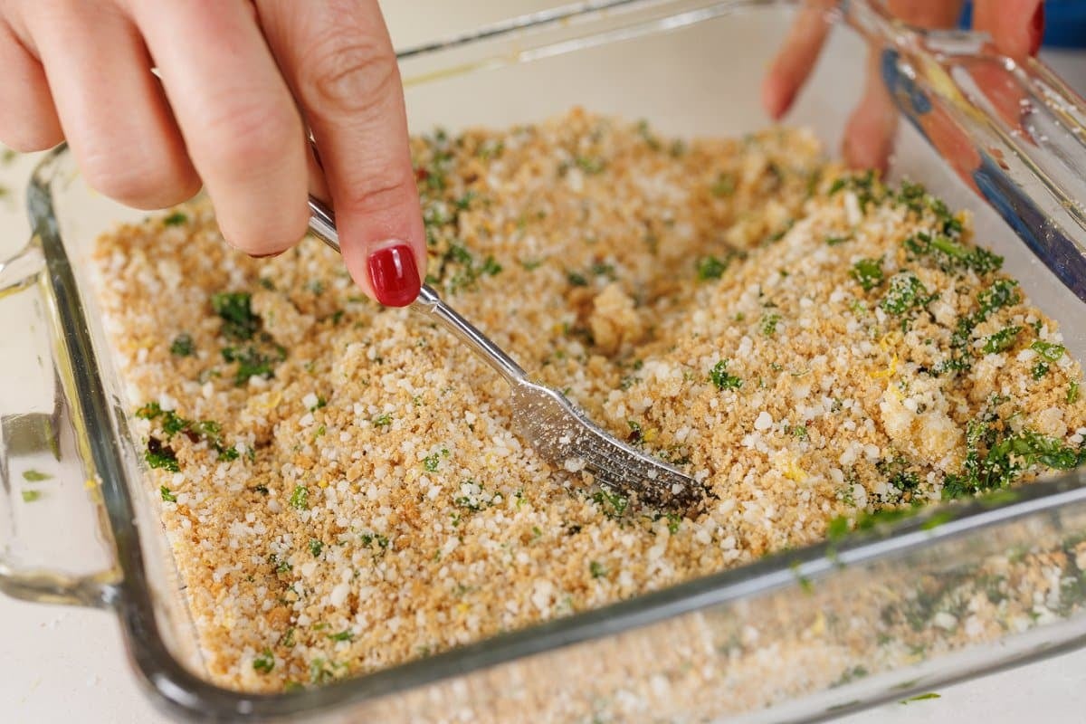 Mixing panko brad mixture with parmesan cheese and parsley.