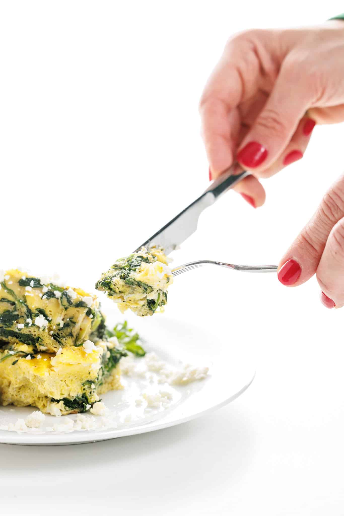 A forkful of spinach and feta Greek egg bake.