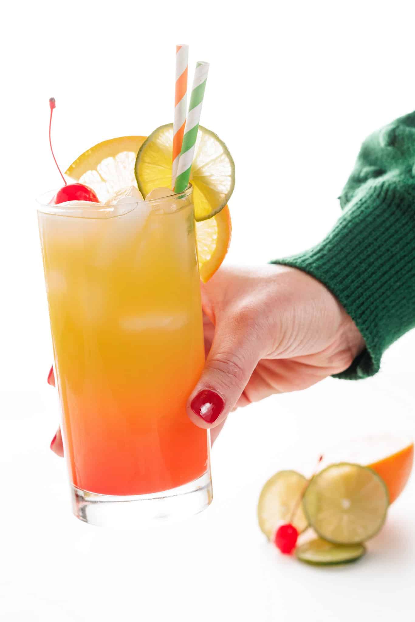 Holding a New Orleans hurricane cocktail.