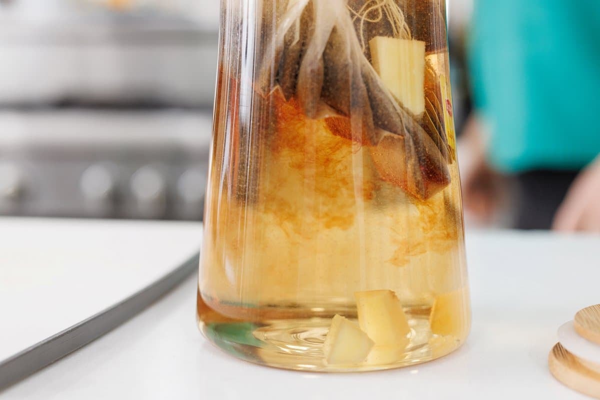 Infusing tea bags in vodka in a pitcher.