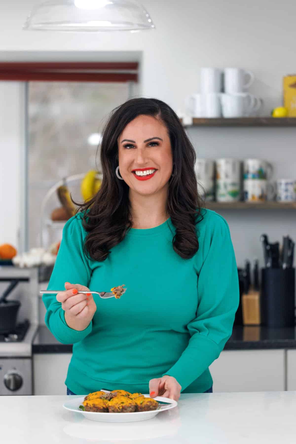 Liz eating cheeseburger meatloaf muffins.