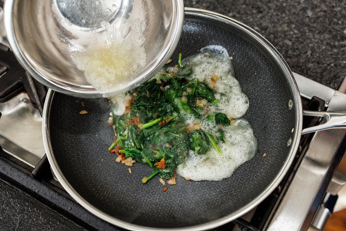 Adding egg whites to pan.