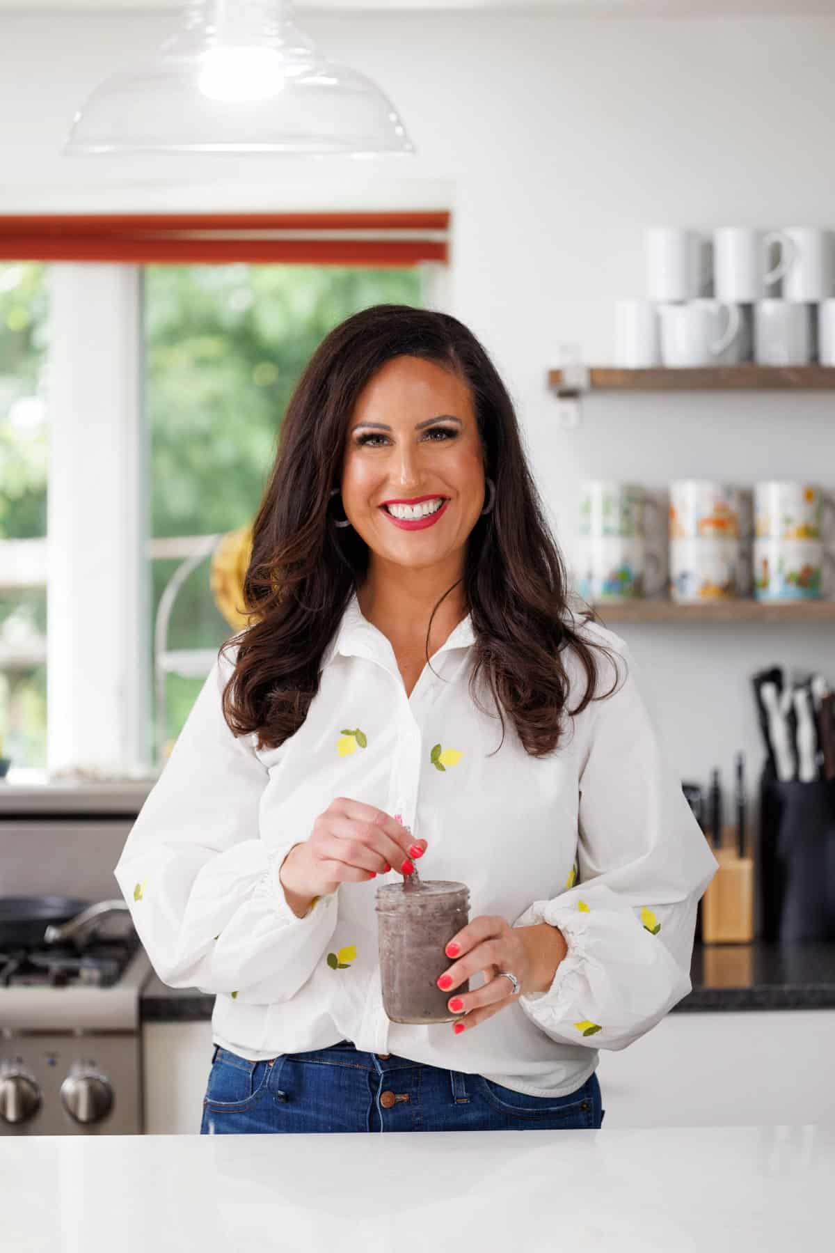 Liz drinking high protein blueberry kale smoothie.