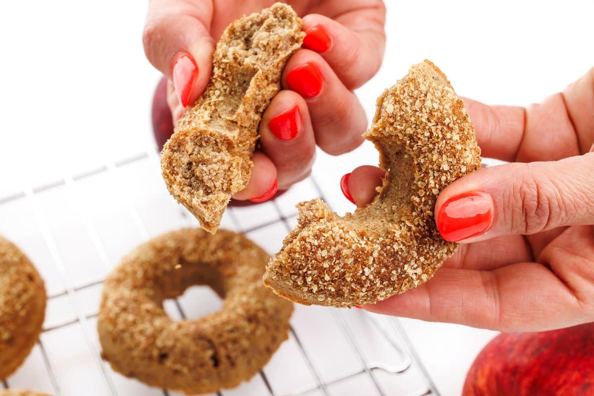 Breaking apart a baked apple cider donut.