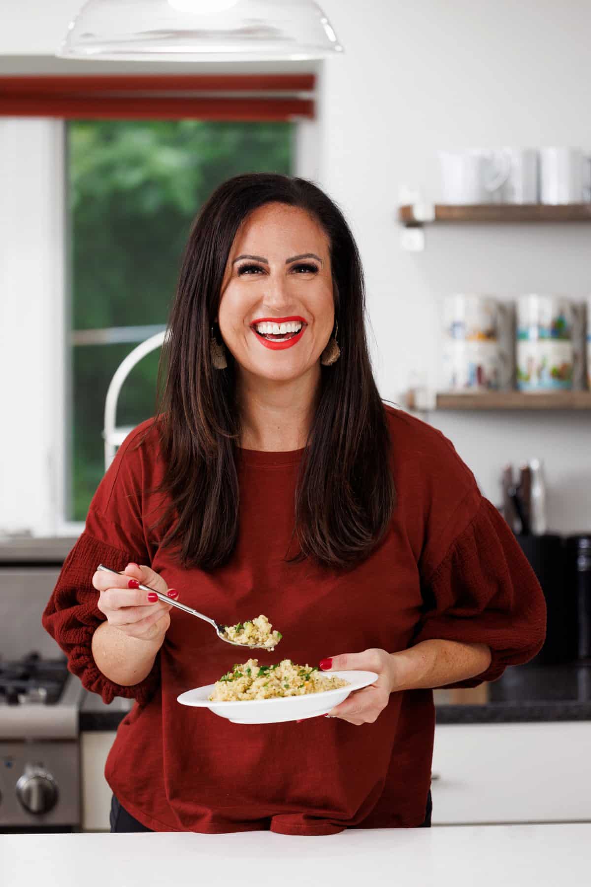 Liz eating quinoa pilaf with mirepoix.