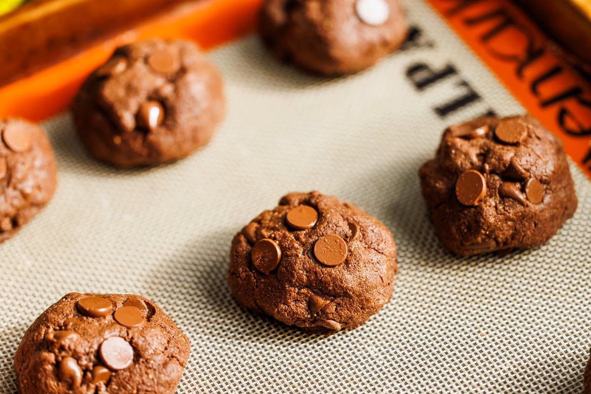 Baked buckwheat double dark chocolate brownie cookies on cookie sheet.