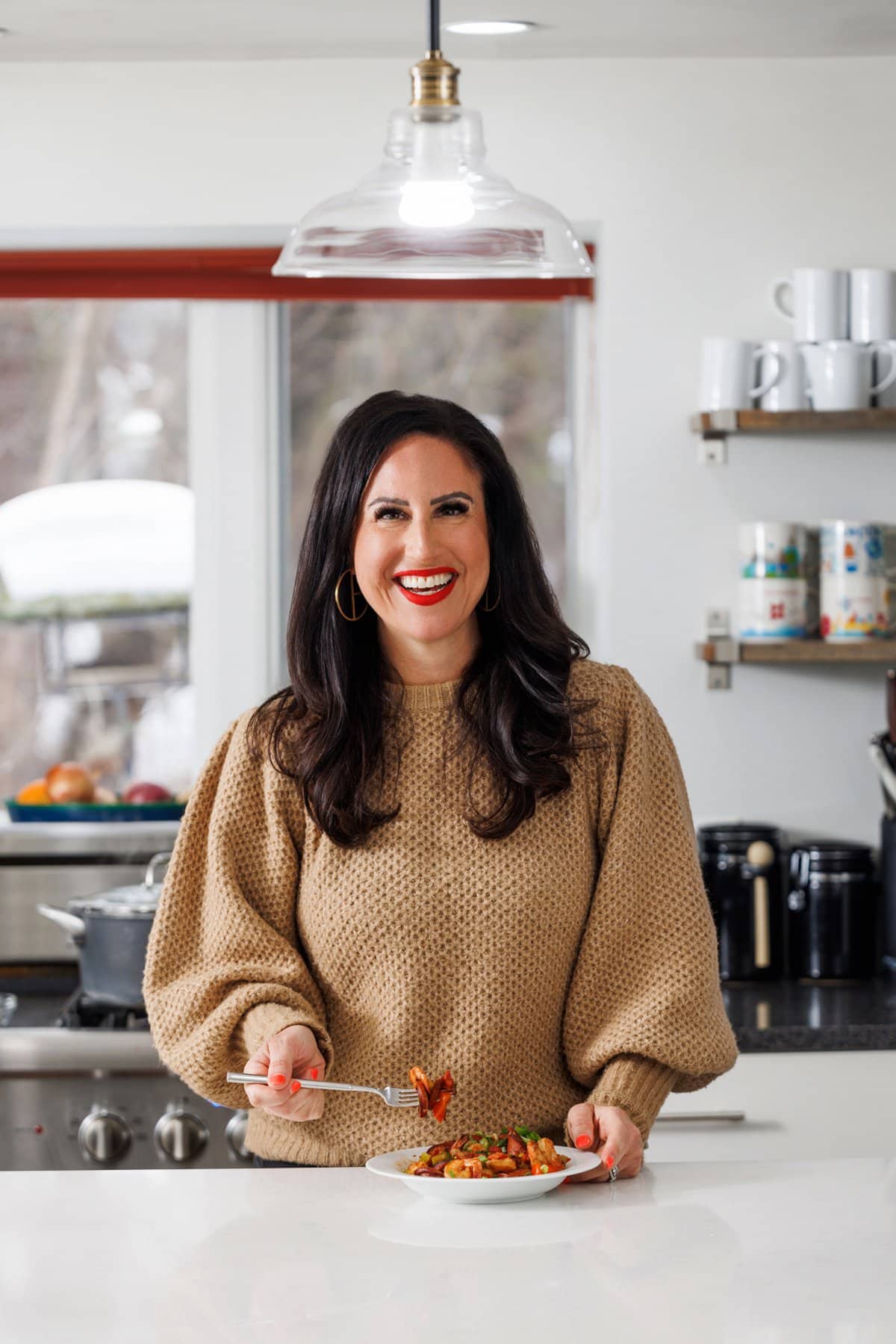 Liz eating cajun shrimp and andouille sausage skillet.
