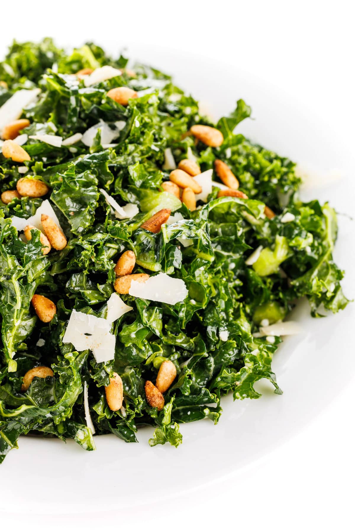 Kale Caesar salad topped with pine nuts.