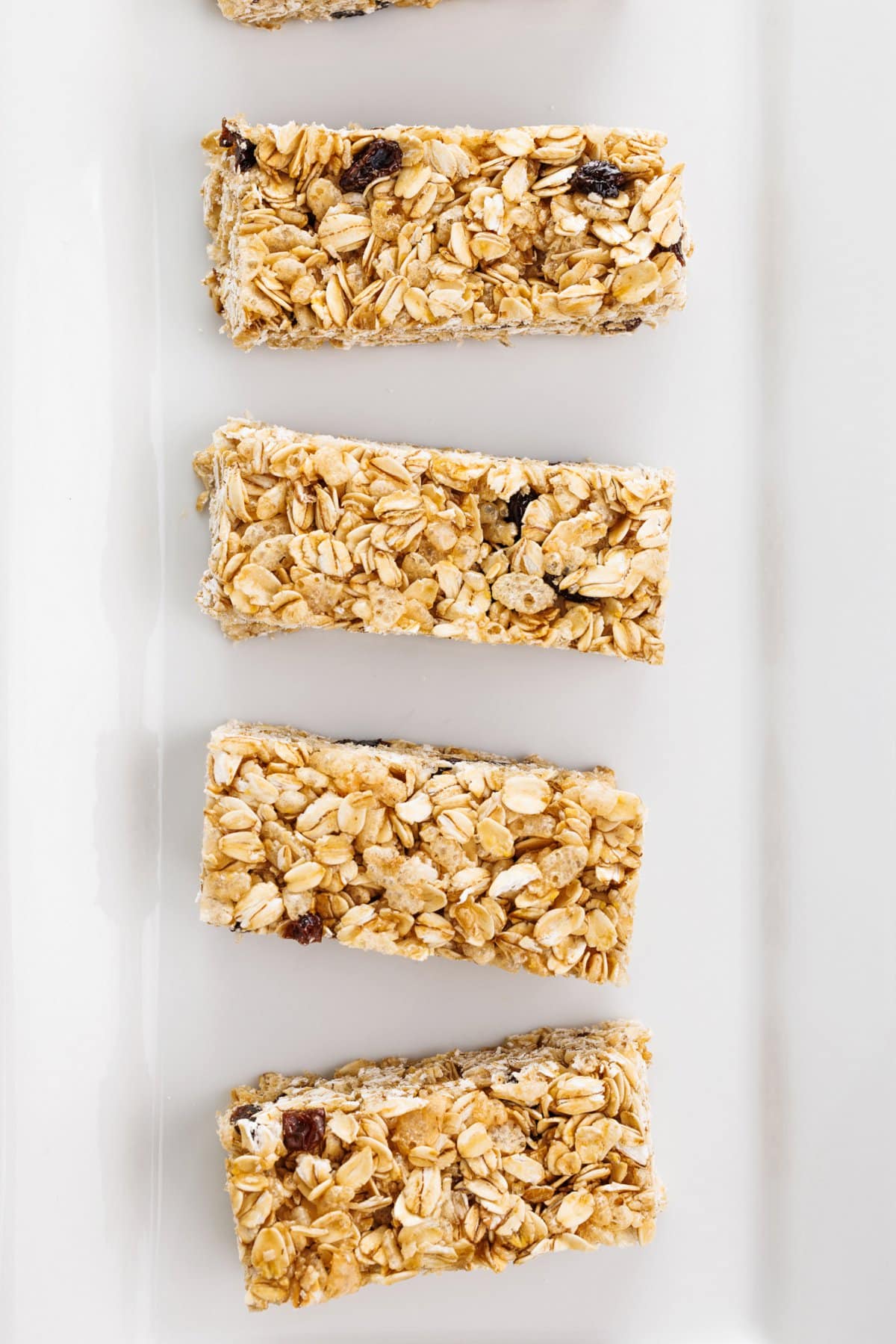 Chewy oatmeal raisin granola bars in a row.