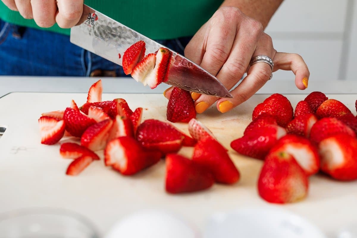 Liz cutting strawberries.