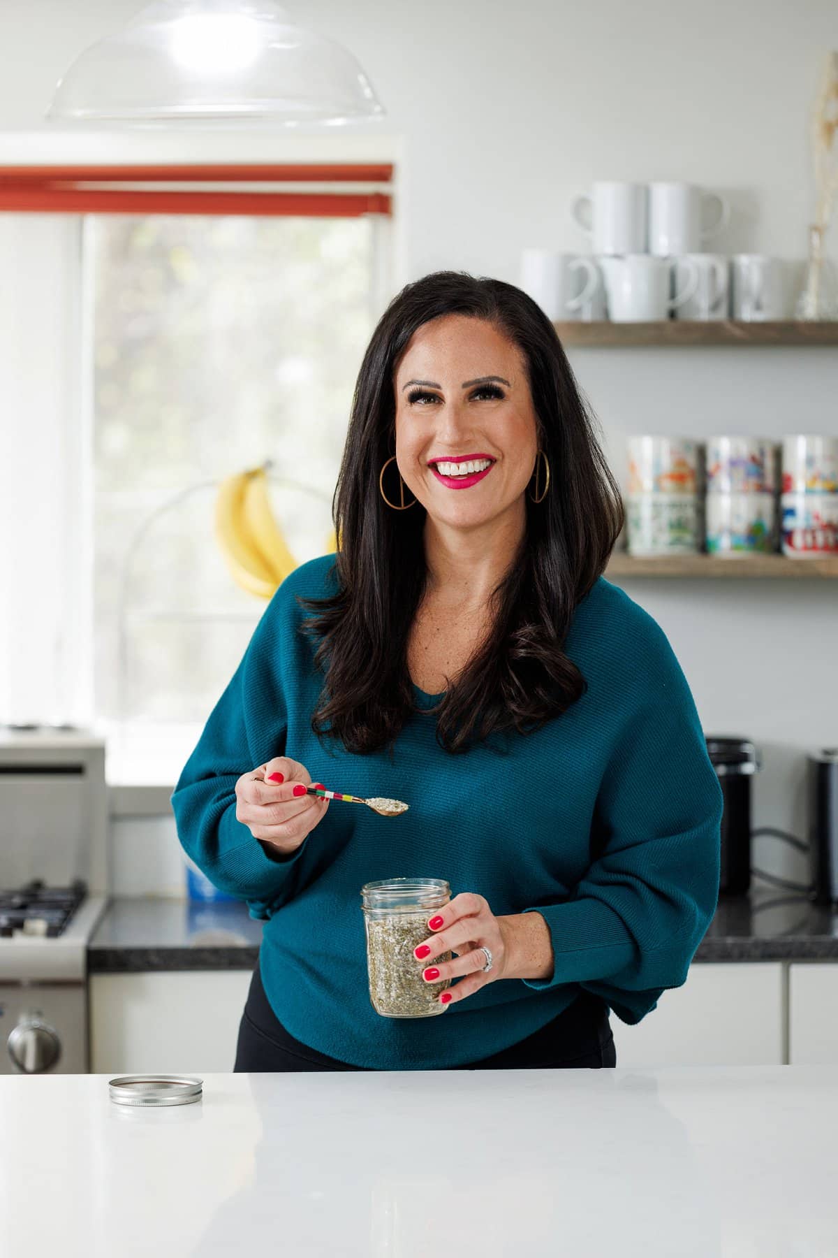Liz holding all-purpose Greek seasoning.