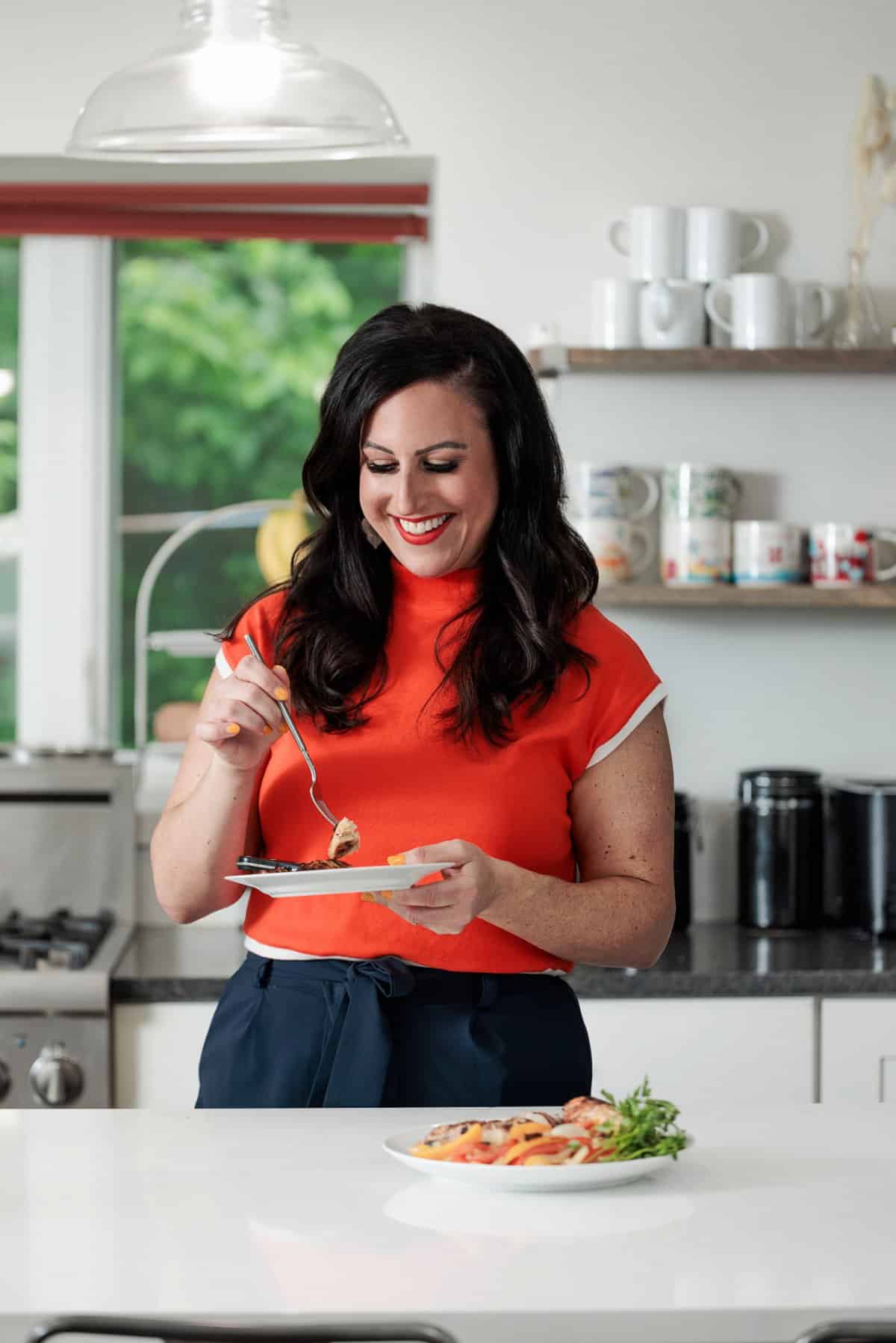 Liz eating Asian grilled chicken and veggies.