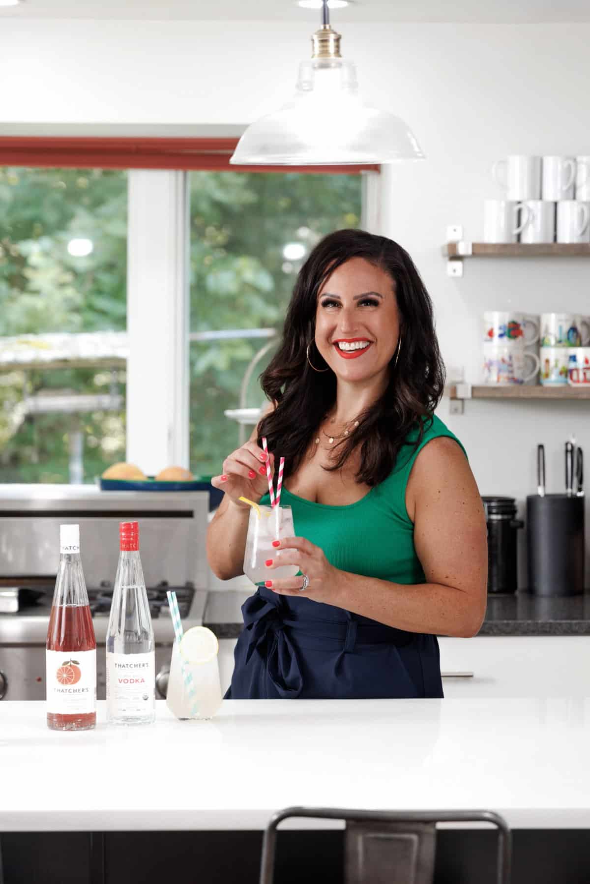 Liz drinking a blood orange lemonade gin spritz.