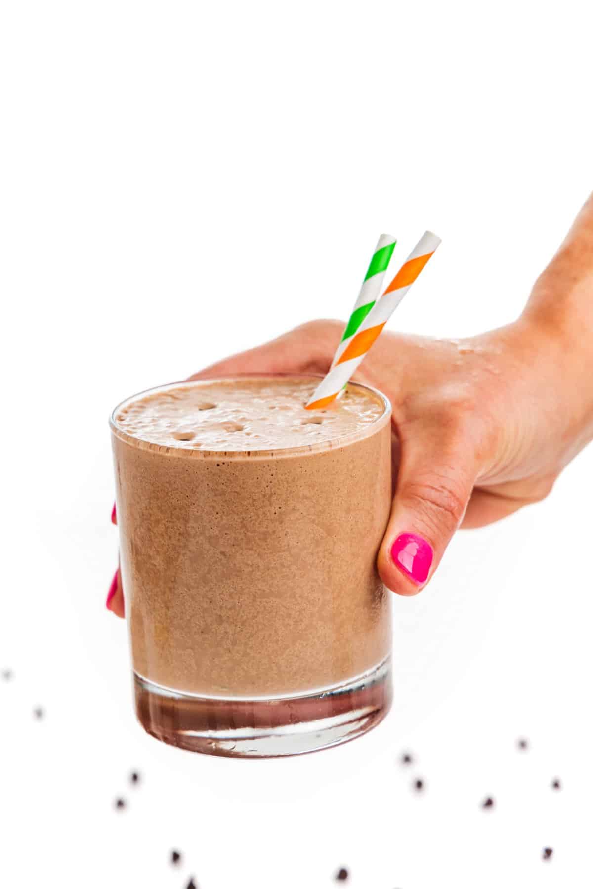 Holding a low carb chocolate peanut butter smoothie.