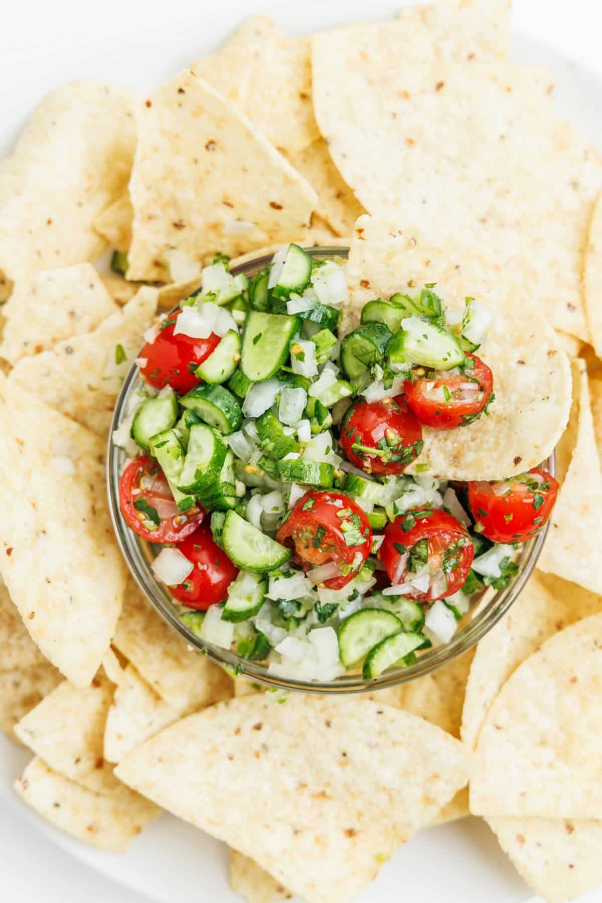 Cucumber pico de gallo surrounded by tortilla chips.