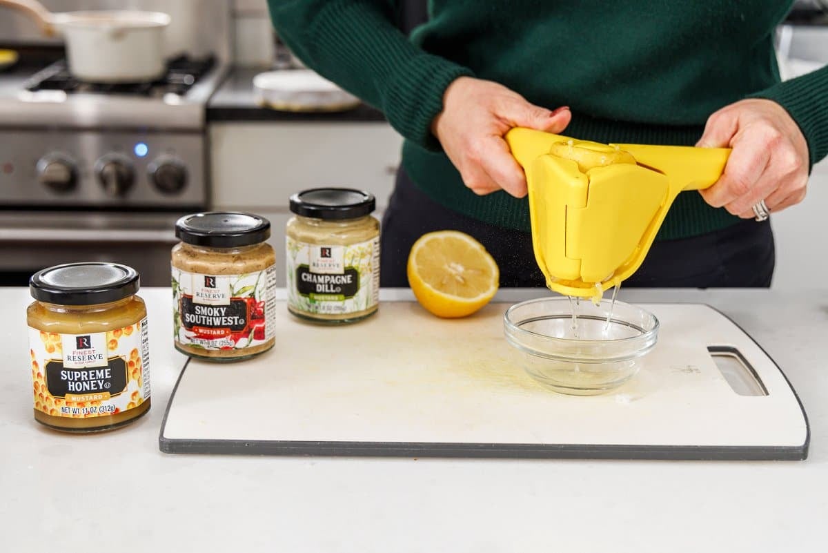 Using a lemon juicer to juice a lemon into a bowl.