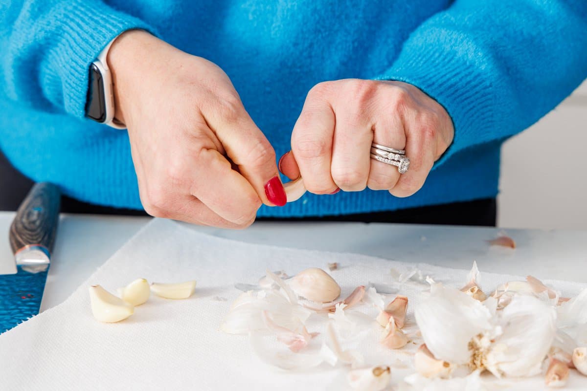 Liz peeling garlic by hand.