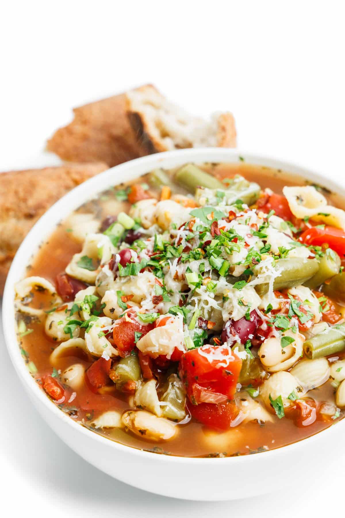 Minestrone soup in a white bowl.