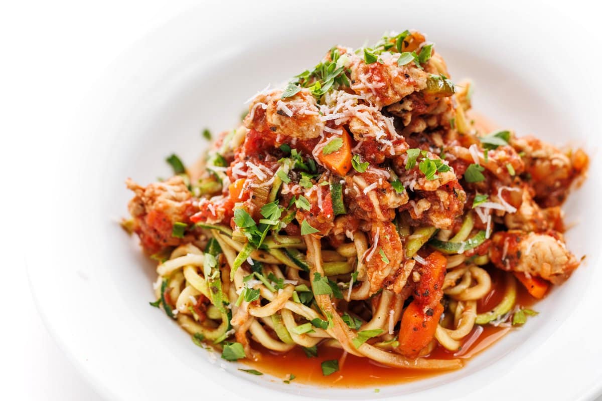 Turkey bolognese zucchini noodles on a white plate.