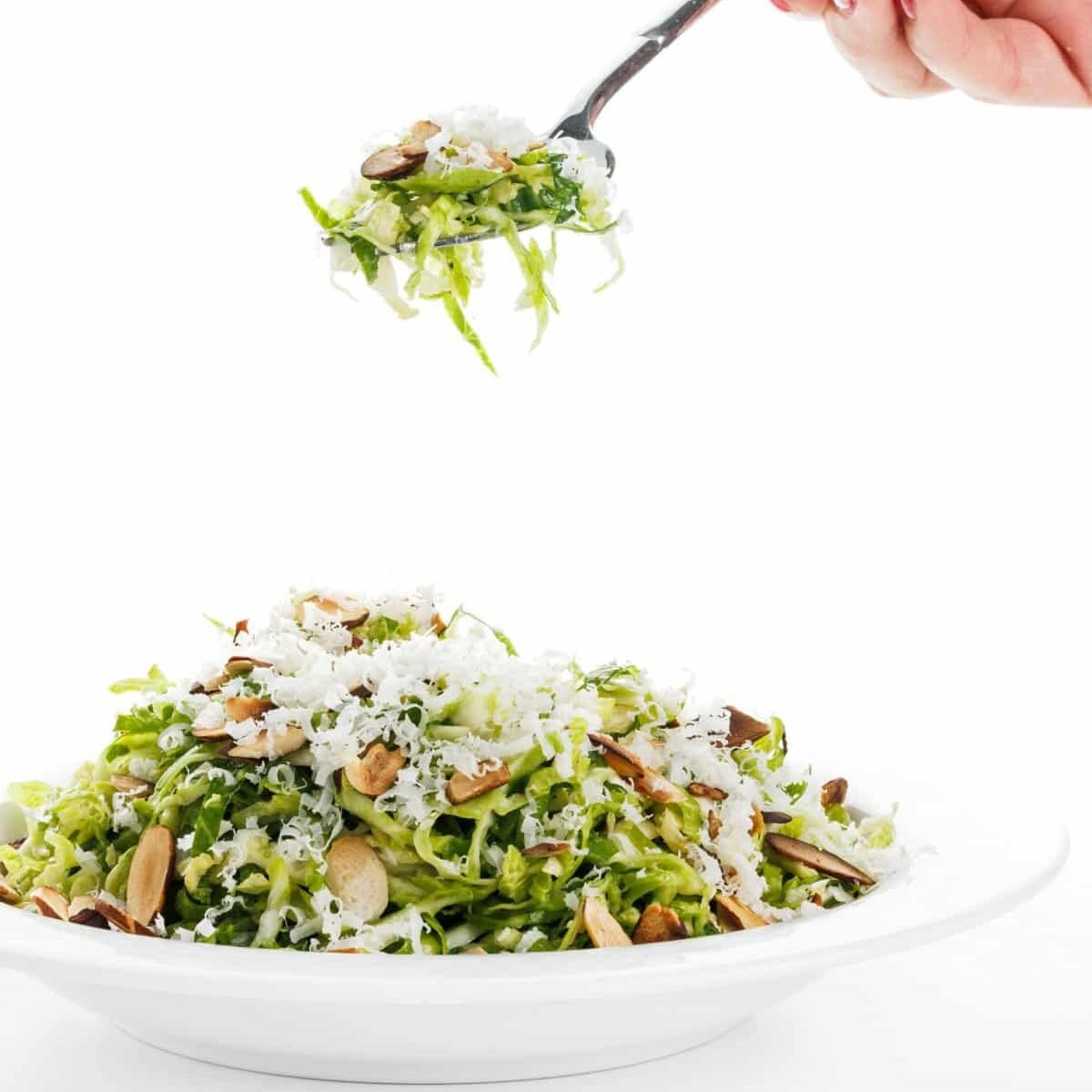Forkful of brussels sprout salad with lemon parmesan vinaigrette.