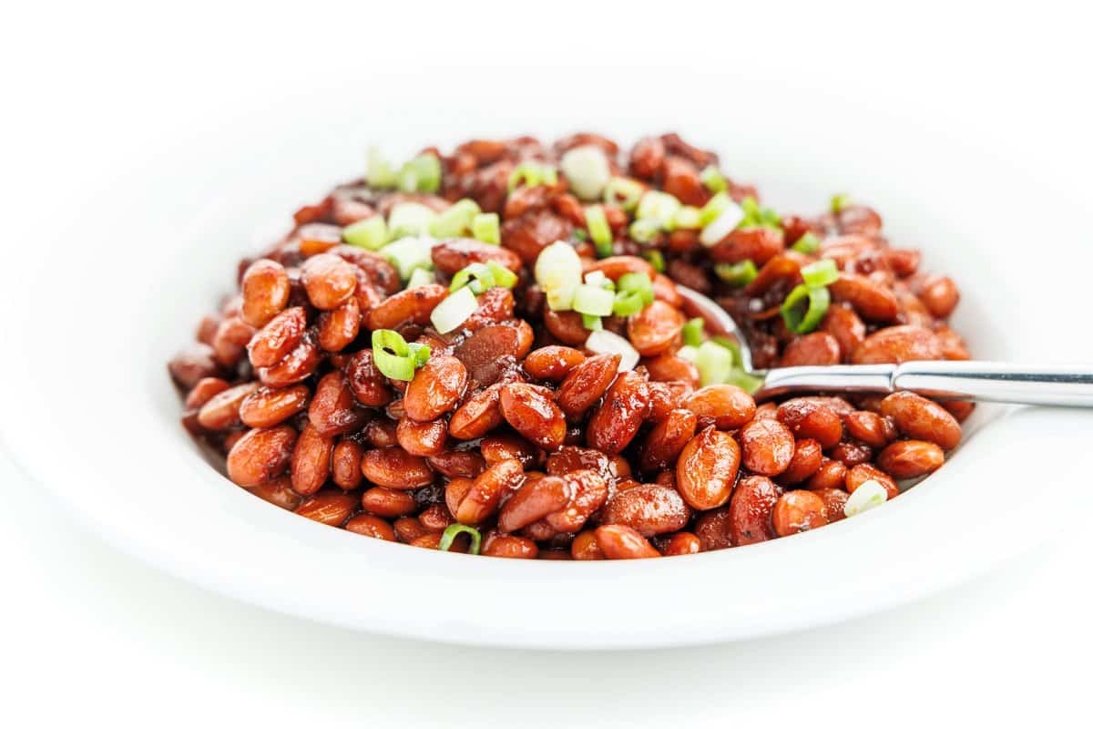 Slow cooker Boston baked beans garnished with fresh chives.