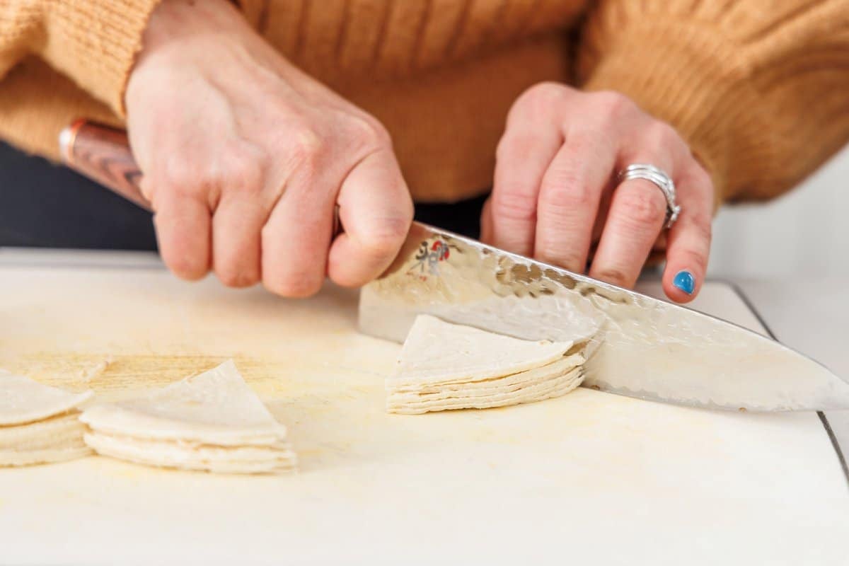 Liz cutting tortillas into triangles.