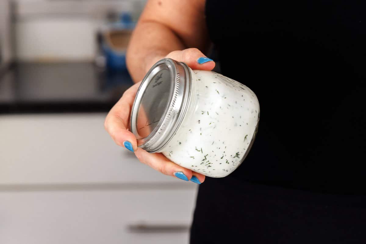 Shaking up 5-ingredient dill ranch in a mason jar.