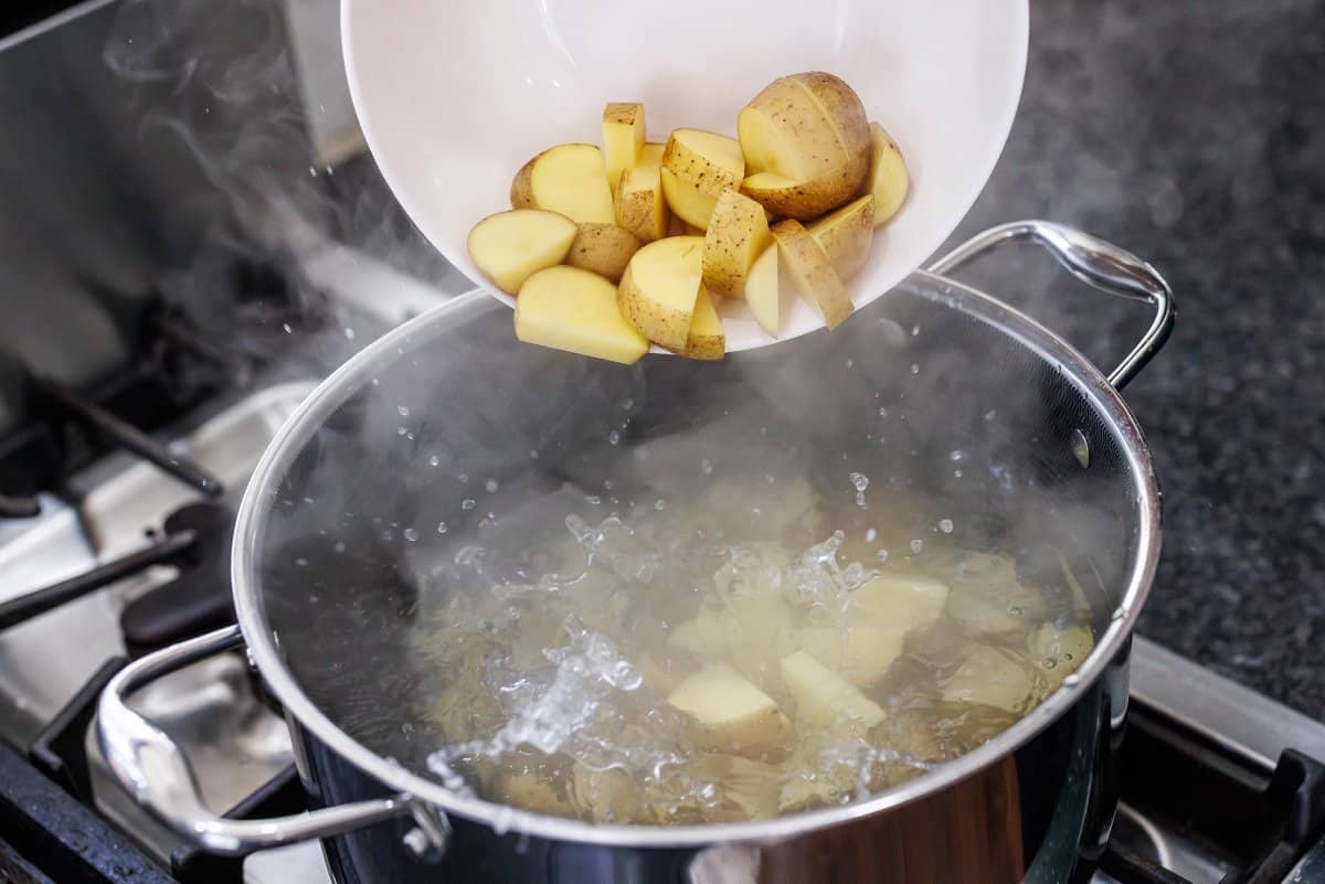 Cooking potatoes in a large pot of boiling water.