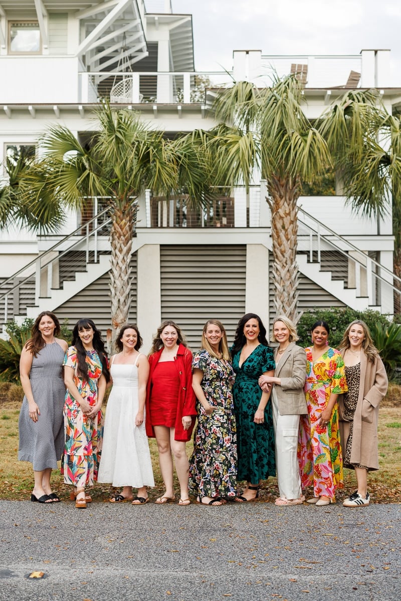 Fresh Air Retreat Charleston attendees standing in a row in front of a beach house.
