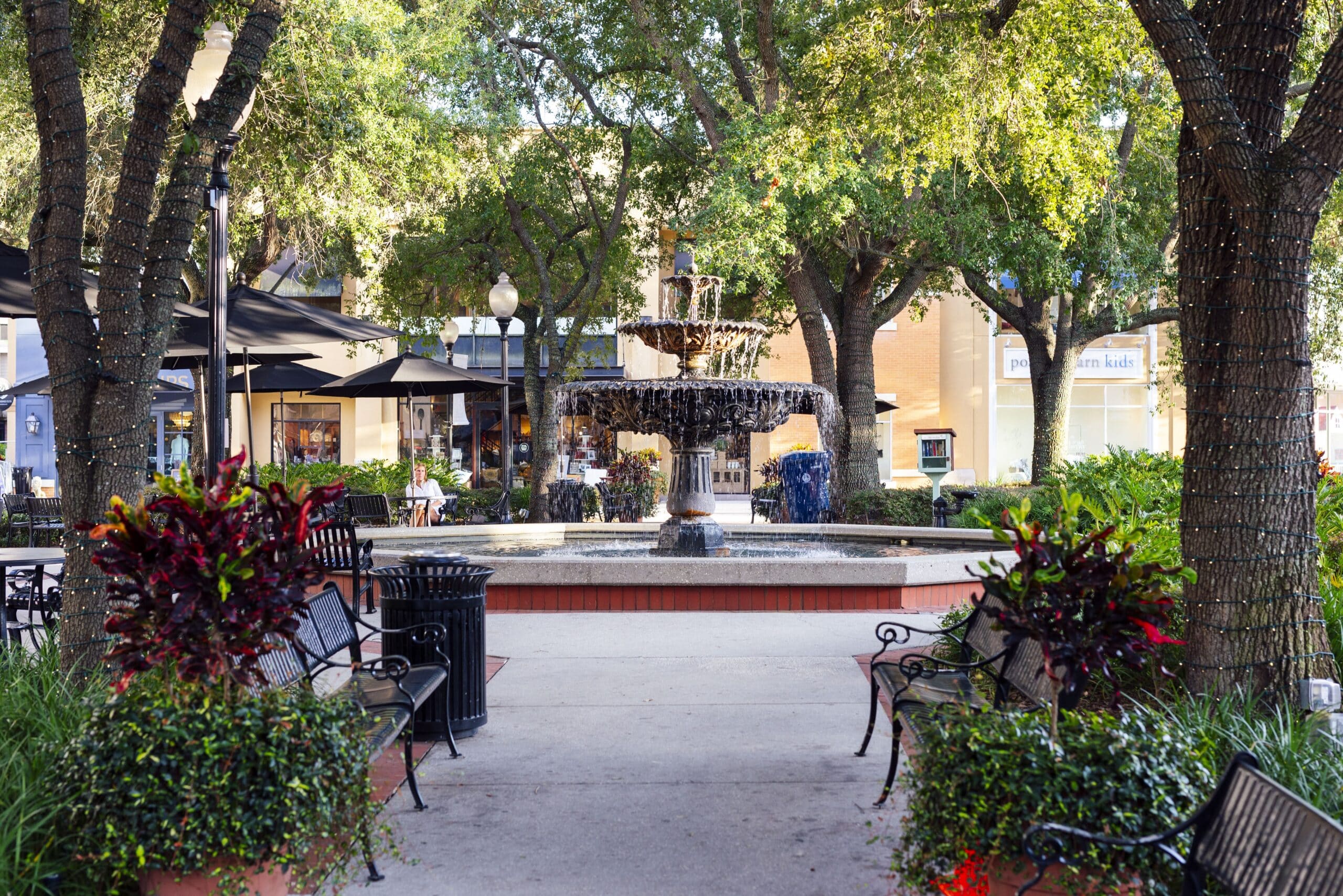 A fountain in the middle of a walkway in Hyde Park Village.