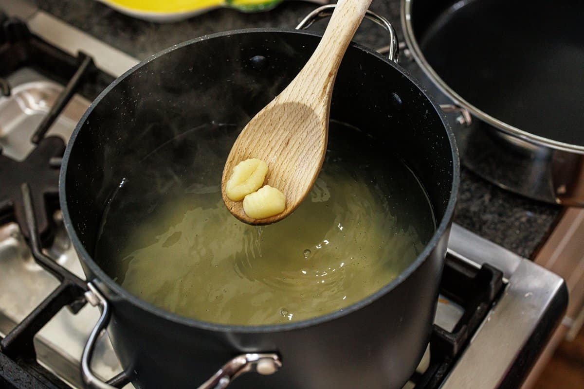 Cooking gnocchi in a large pot of water.